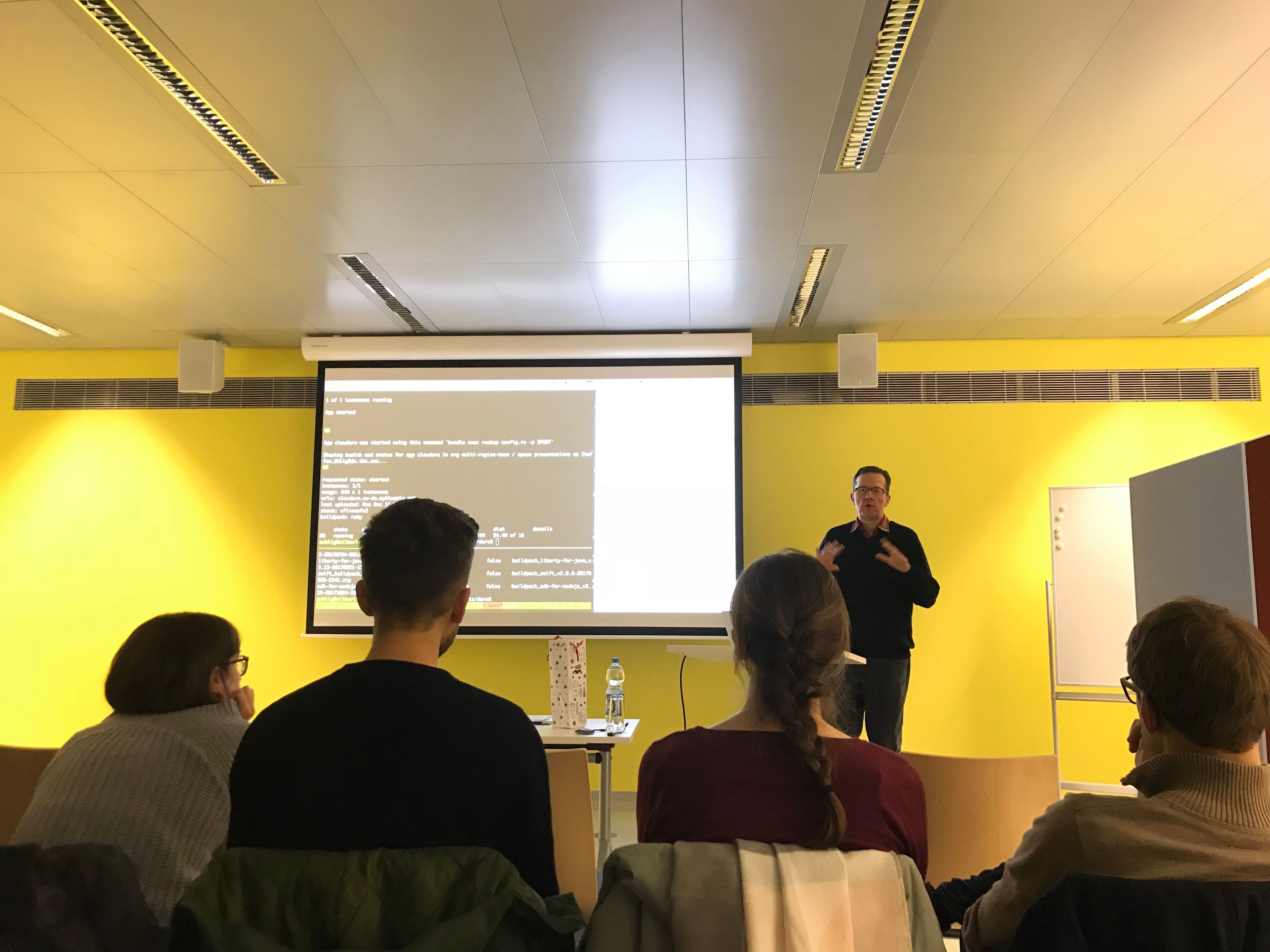 Steffen in front of the audience presenting about the CF Bits Service
